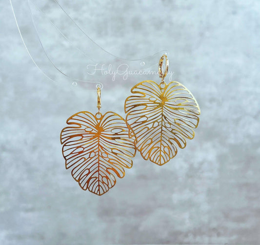 a pair of gold big monstera leaf earrings
